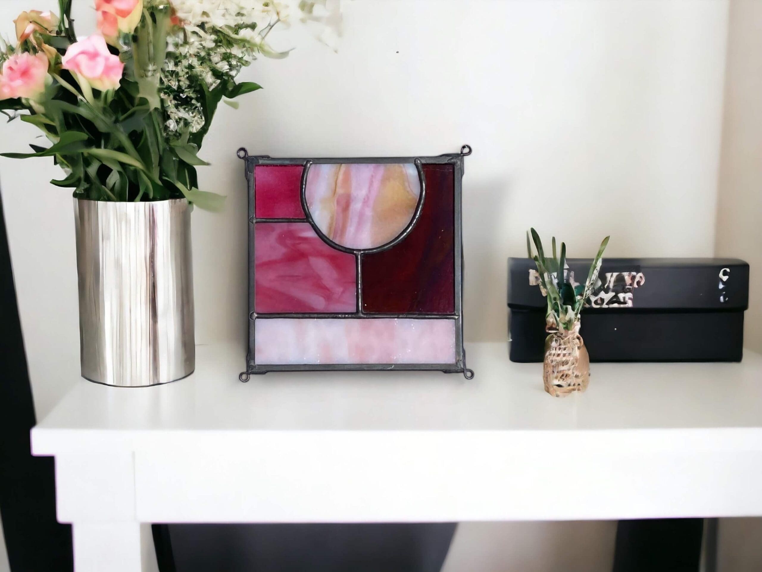 stained glass art sitting on a mantel
